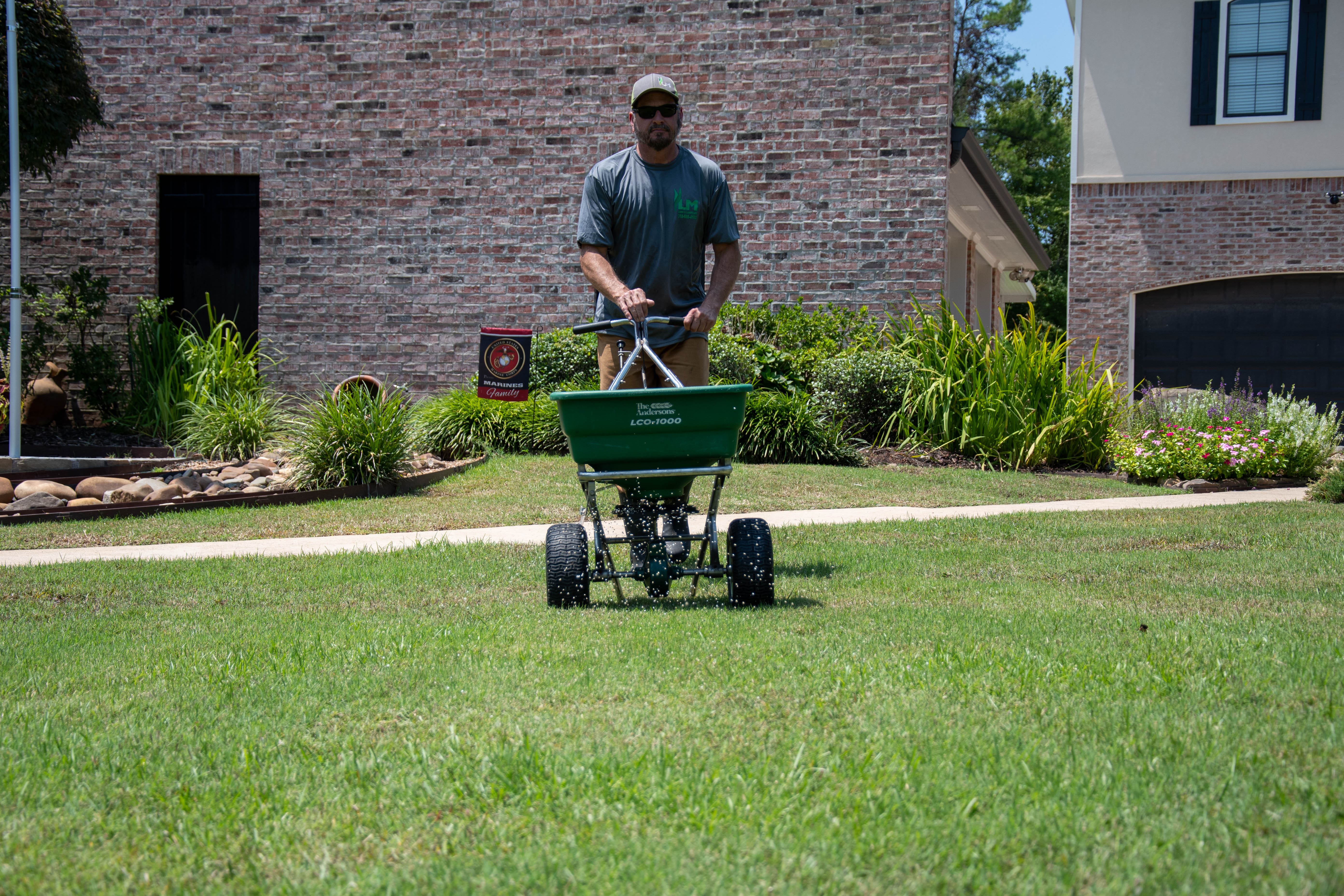 Lawnmasters team doing fertilization services